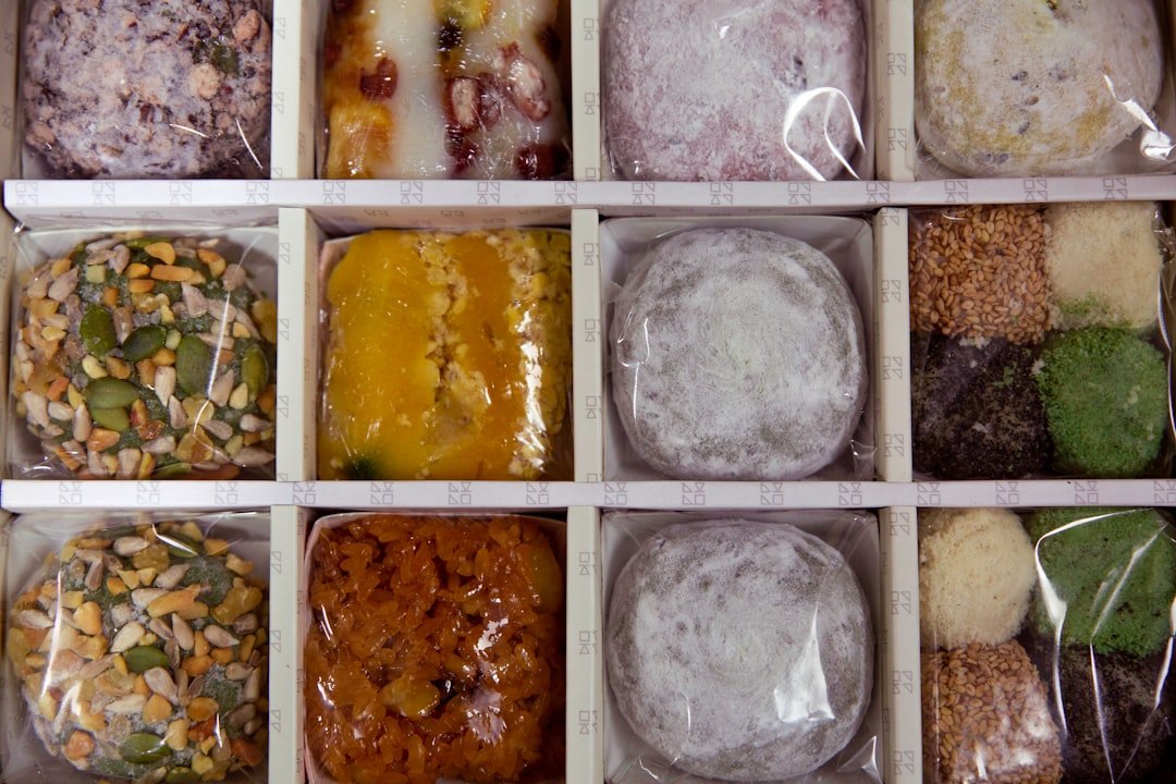 Silicone ice cube trays filled with minced herbs, garlic, and olive oil mixture ready for freezing